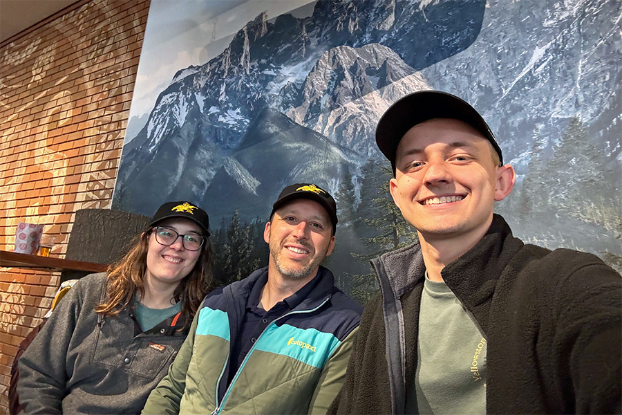 DMC STL colleagues in front of a mural