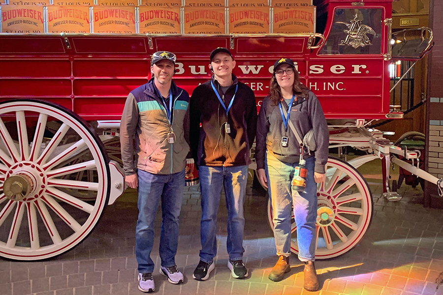 DMC STL colleagues in front of a Budweiser wagon