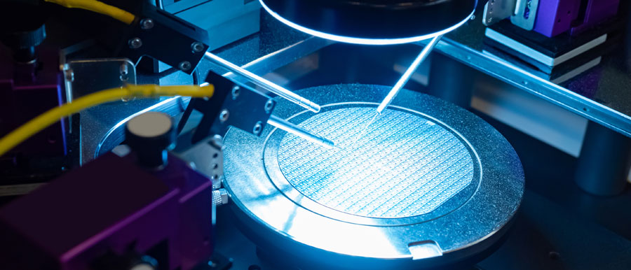 Needles test a silicon wafer in a lab